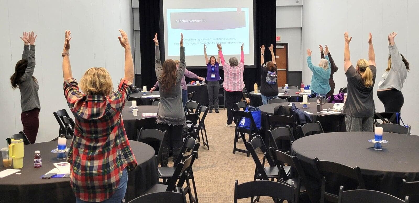Educators participating in a wellness session led by Sheila